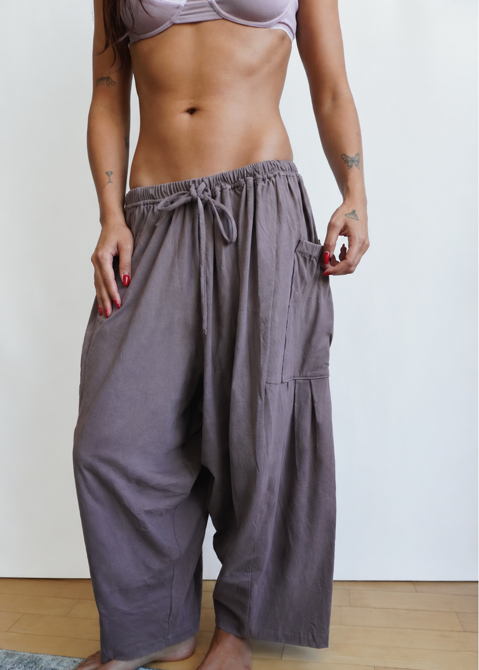 Front view of a model wearing the Mushroom Bailey Pant by Lunetti, featuring a gathered drawstring waistband, roomy wide legs, and cropped length.