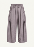 Front product view of the Mushroom Bailey Pant by Lunetti against an ivory background, featuring soft cotton fabric, a relaxed wide-leg silhouette, elastic drawstring waistband, and symmetrical oversized cargo pockets with pleated detailing.