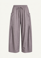 Front product view of the Mushroom Bailey Pant by Lunetti against an ivory background, featuring soft cotton fabric, a relaxed wide-leg silhouette, elastic drawstring waistband, and symmetrical oversized cargo pockets with pleated detailing.