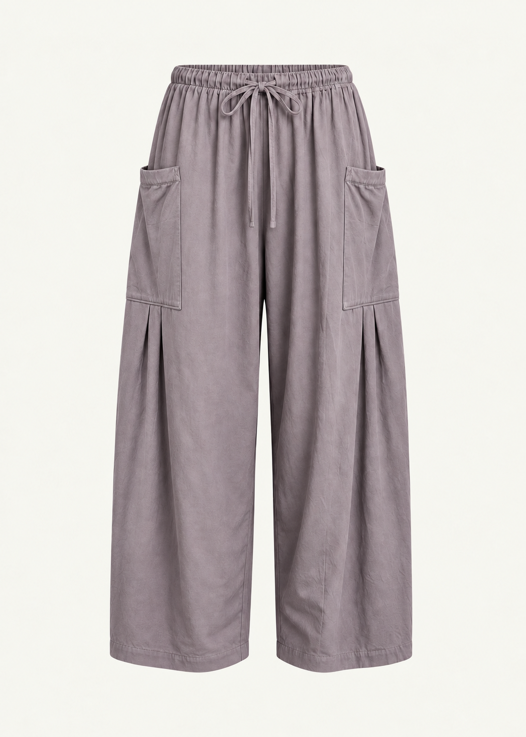Front product view of the Mushroom Bailey Pant by Lunetti against an ivory background, featuring soft cotton fabric, a relaxed wide-leg silhouette, elastic drawstring waistband, and symmetrical oversized cargo pockets with pleated detailing.