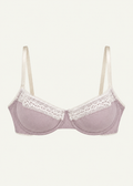 Front product view of the Lilac Charlotte Bra by Lunetti against an ivory background, featuring soft lilac bamboo jersey cups, delicate white lace trim, supportive underwire construction, and adjustable ivory shoulder straps.