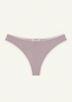 Front product view of the Lilac Charlotte Thong by Lunetti against an ivory background, featuring soft lilac bamboo jersey, delicate ivory picot lace trim along the waistband and leg openings, and a centered Lunetti label.