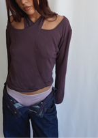 Model wearing the Amethyst Dahlia Top by Lunetti with low-rise blue jeans, styled with an asymmetric neckline and shoulder cutout to showcase the versatile four-way design.