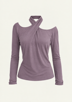 Front product view of the Orchid Dahlia Top by Lunetti against an ivory background, featuring soft purple bamboo jersey, a draped crisscross halter neckline, asymmetric shoulder cutouts, and fitted long sleeves.