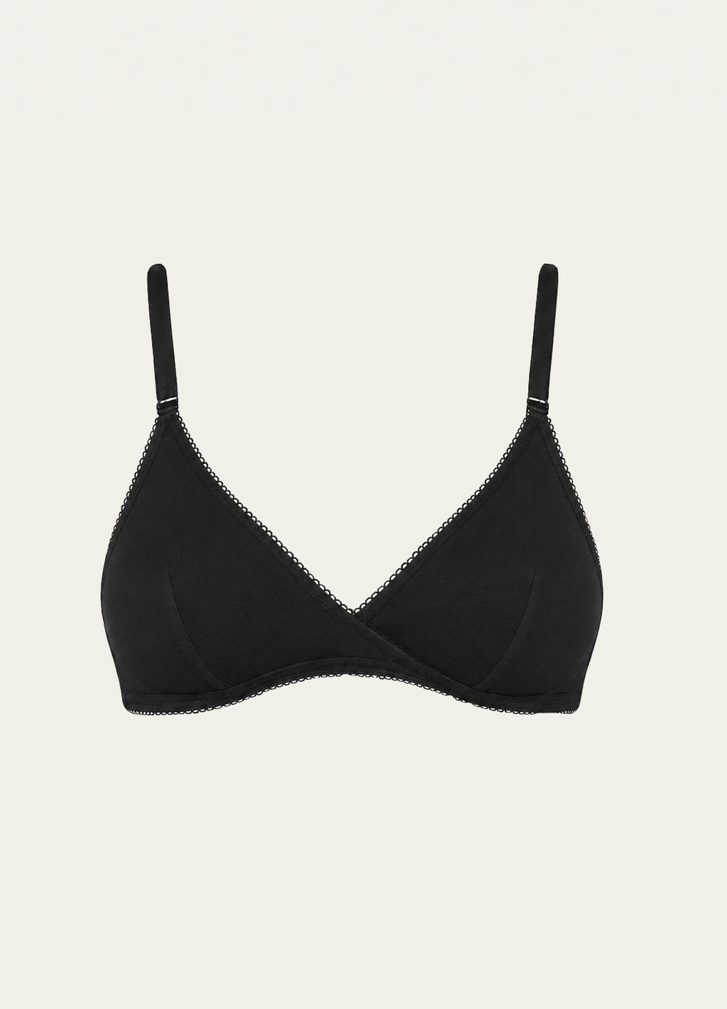 Black bamboo jersey Margot Bralette by Lunetti against an ivory background, featuring soft triangle cups, adjustable straps, and a wireless silhouette.