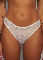 White lace thong underwear with a scalloped trim, shown on a model.