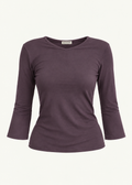 Front product view of the Amethyst Willow Top by Lunetti against an ivory background, featuring soft muted purple bamboo jersey, a V-neckline, fitted silhouette, gently flared three-quarter sleeves, and a signature Lunetti neck label.