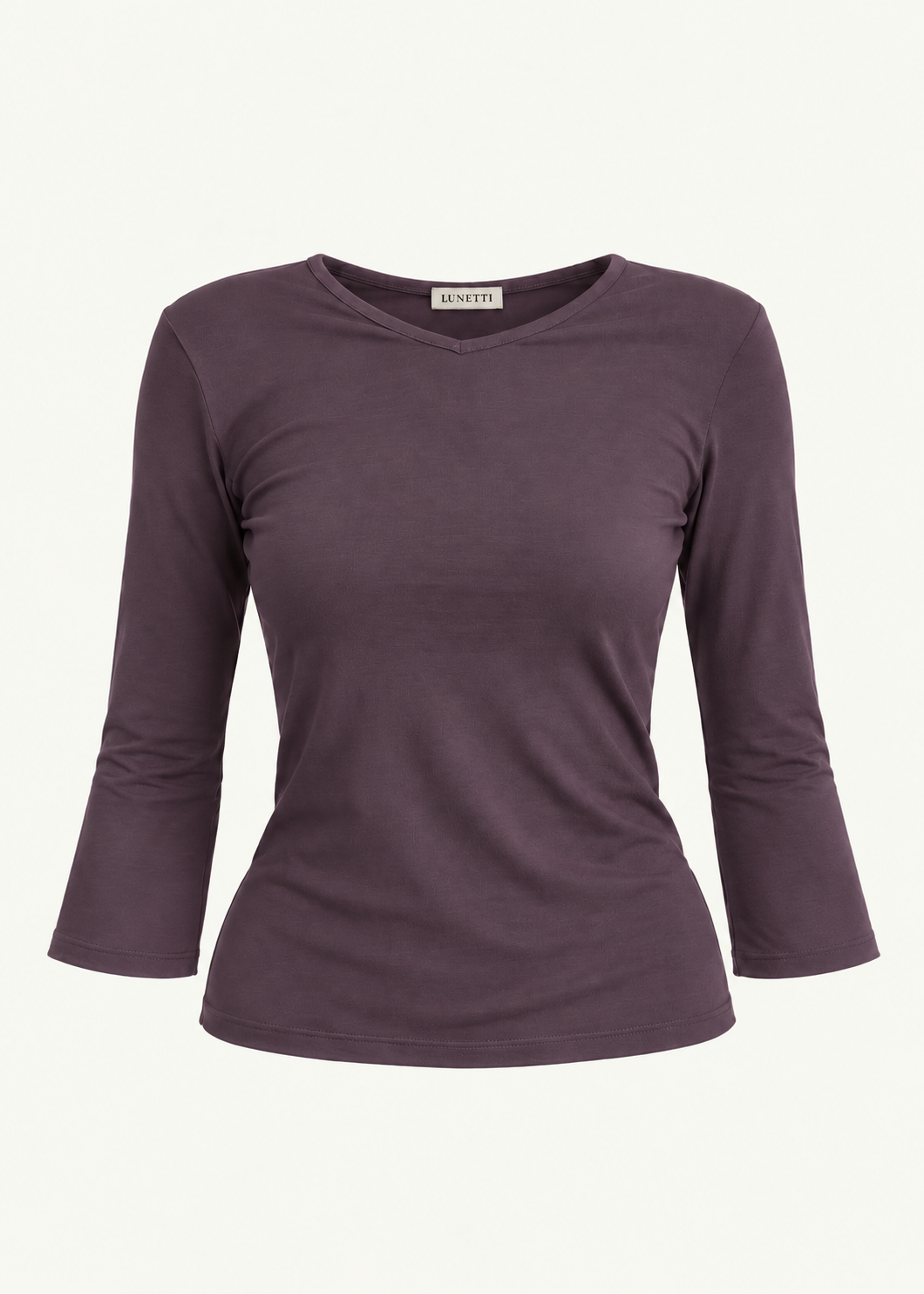 Front product view of the Amethyst Willow Top by Lunetti against an ivory background, featuring soft muted purple bamboo jersey, a V-neckline, fitted silhouette, gently flared three-quarter sleeves, and a signature Lunetti neck label.