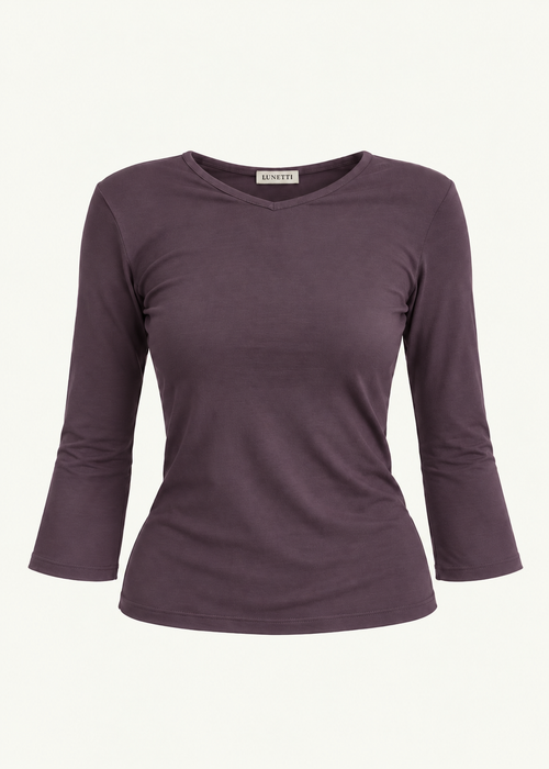 Front product view of the Amethyst Willow Top by Lunetti against an ivory background, featuring soft muted purple bamboo jersey, a V-neckline, fitted silhouette, gently flared three-quarter sleeves, and a signature Lunetti neck label.