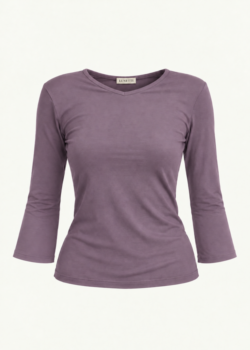 Front product view of the Orchid Willow Top by Lunetti against an ivory background, featuring soft lavender-purple bamboo jersey, a V-neckline, fitted silhouette, gently flared three-quarter sleeves, and a signature Lunetti neck label.