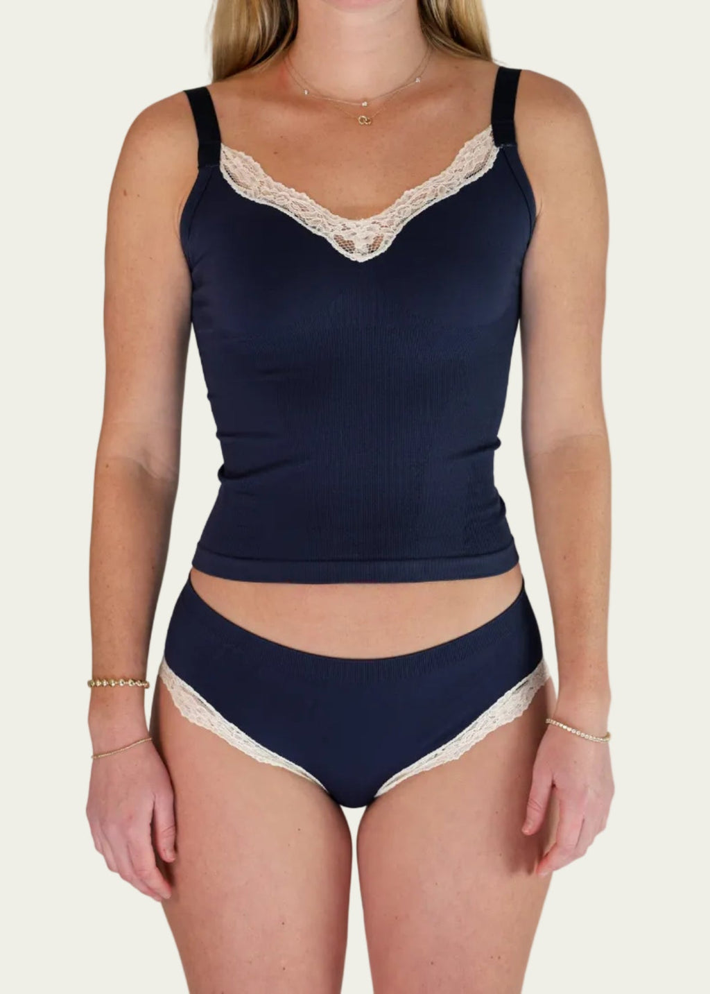 Rear view of a model wearing the Midnight Navy Luna Cami and matching briefs by Lunetti, highlighting the straight back neckline, adjustable straps, and embroidered Lunetti branding.