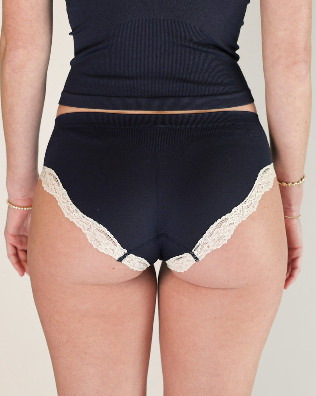Back view of the Lunetti Luna Brief in Midnight Navy with white lace trim.