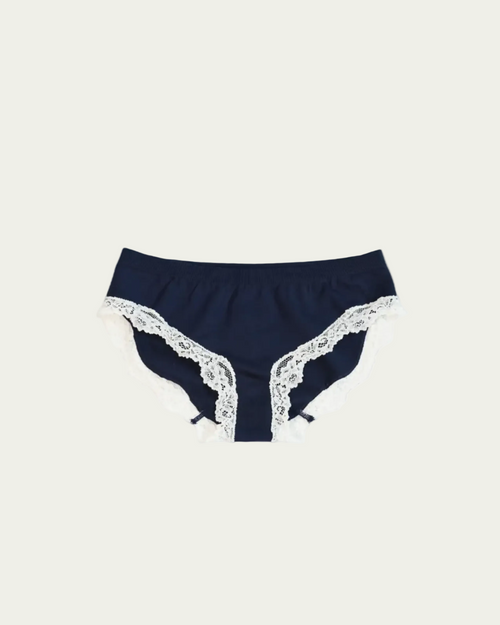Flat lay front view of the Lunetti Luna Brief in Midnight Navy with white lace trim.